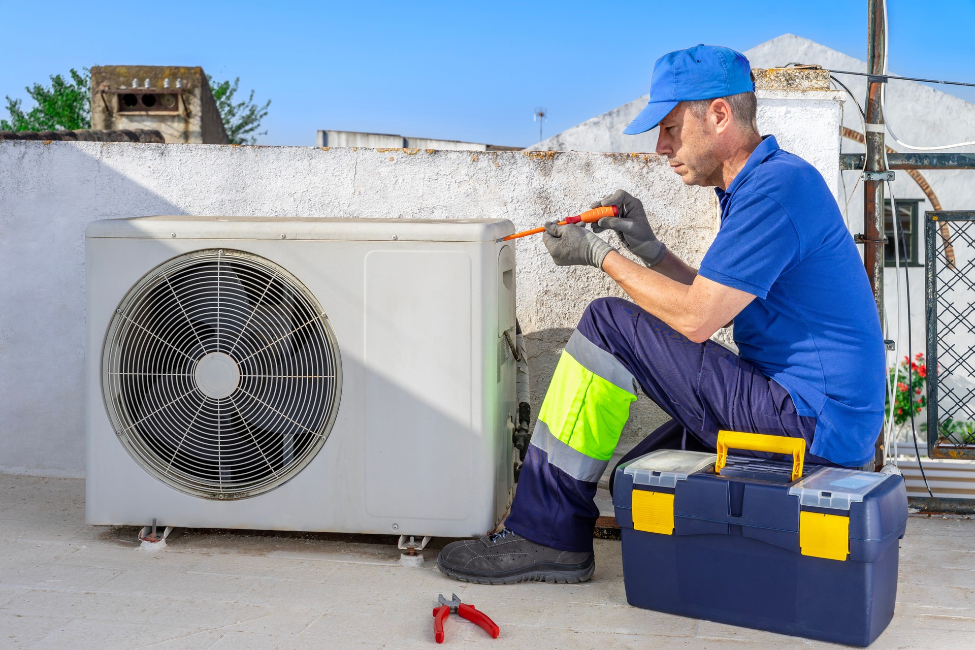 Hvac technician performing air conditioner repair service.