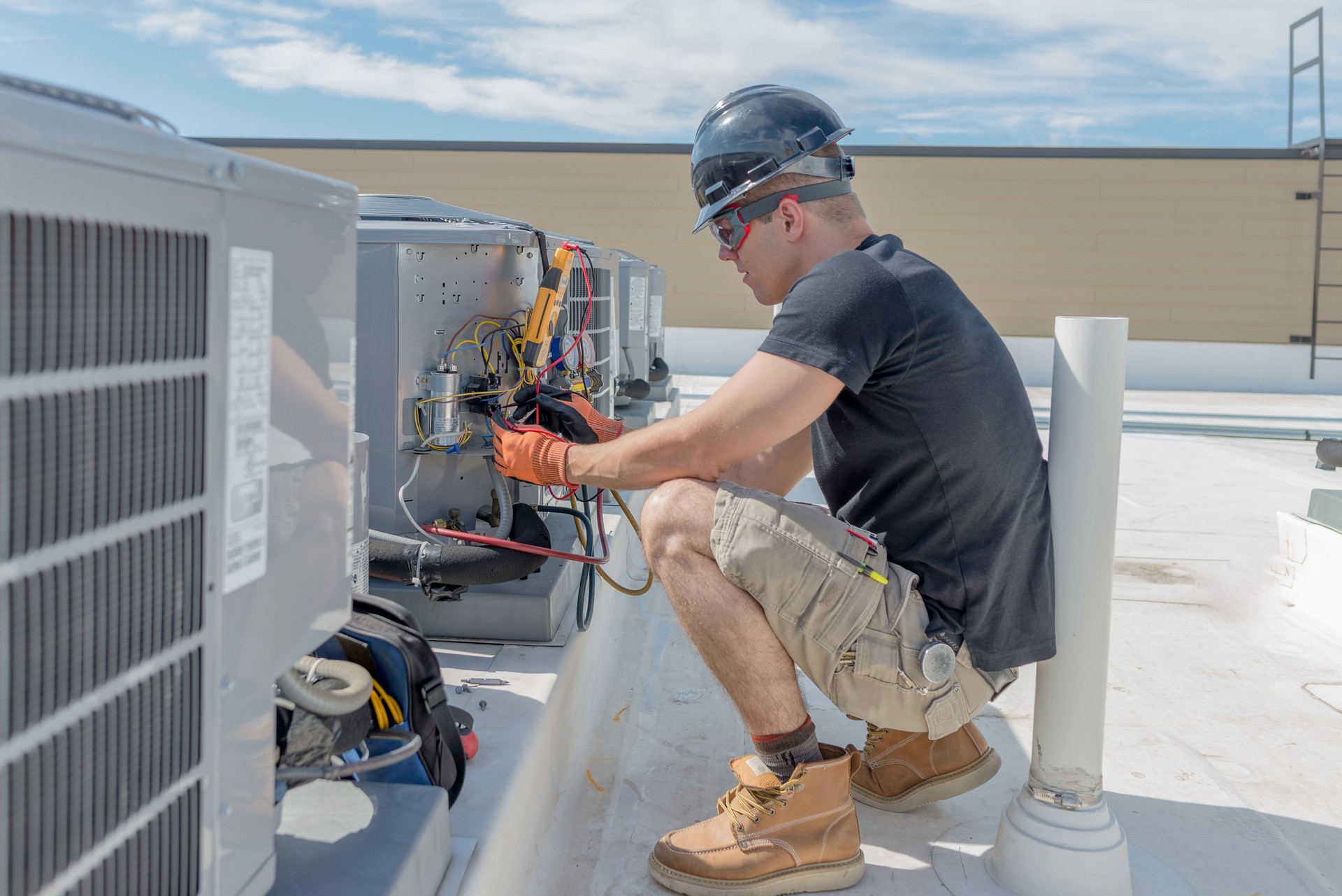 Hvac Tech Checking a Condensing Unit